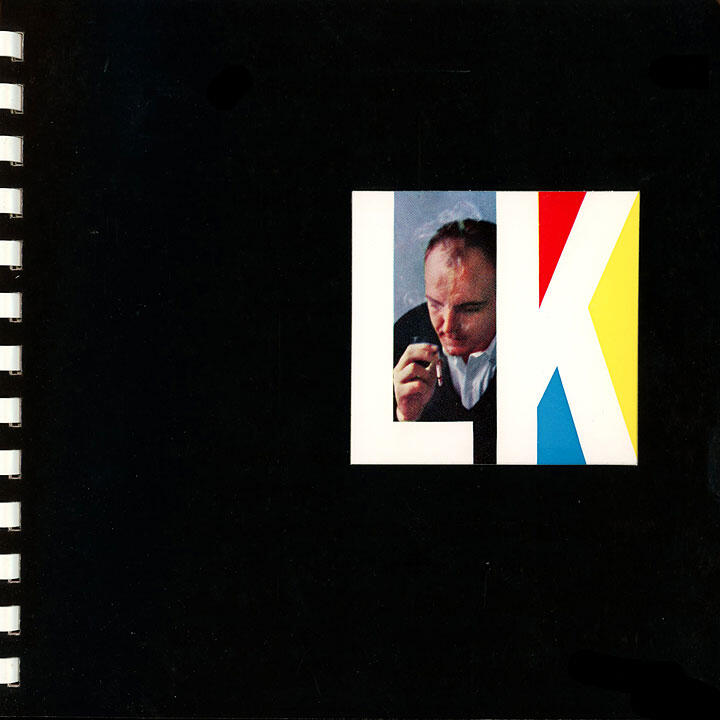 Spiral-bound black cover with a square image. The art consists of a man's photo framed by the letters "L" and "K" in bold colors: white, red, blue, and yellow.