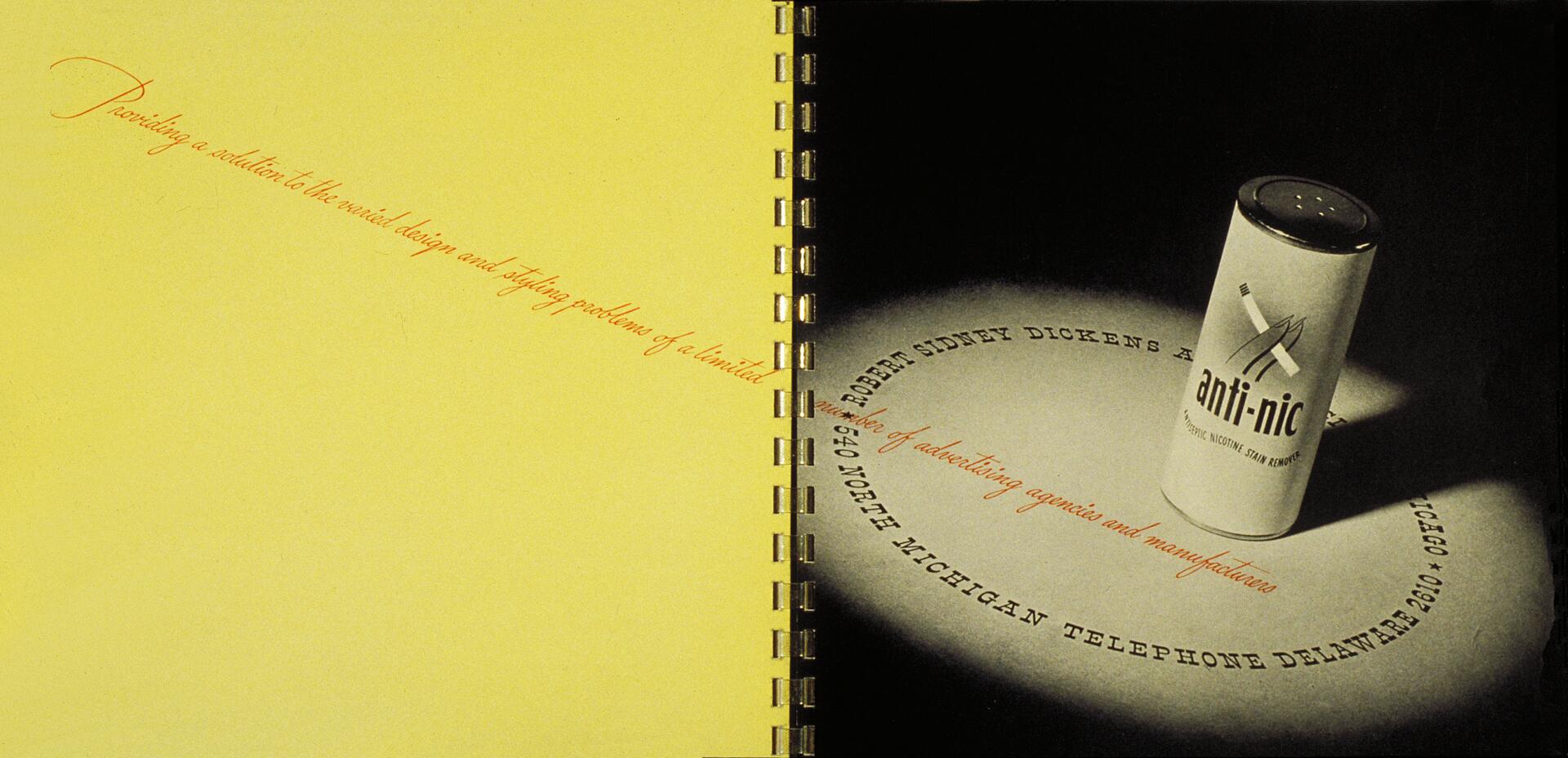 Open book with yellow and black pages; on the black page, a small cylindrical canister labeled "anti-nic" stands upright, casting a shadow. Spiral binding visible in the center.