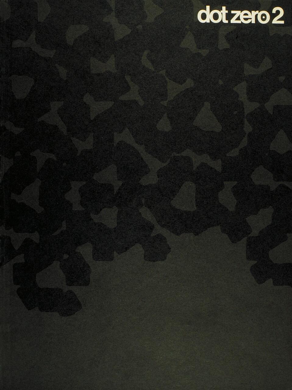 Abstract cover design with dark irregular shapes on a gray background, featuring "dot zero 2" text in the top right corner.