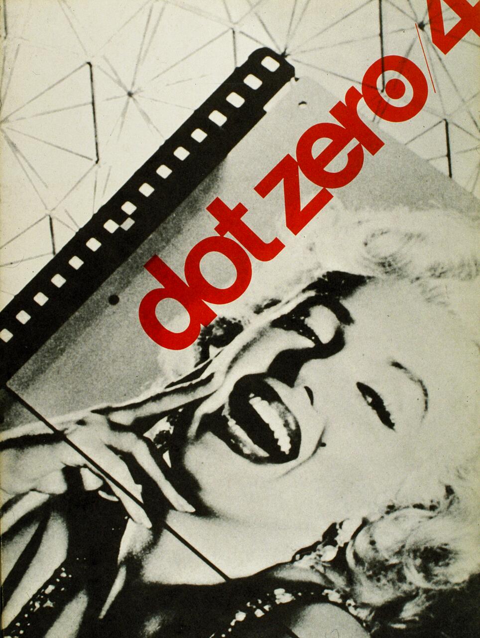 Black and white photograph of a smiling woman with curly hair, partially covered by a film strip and red text reading "dot zero/4." Geometric lines form a pattern in the background.
