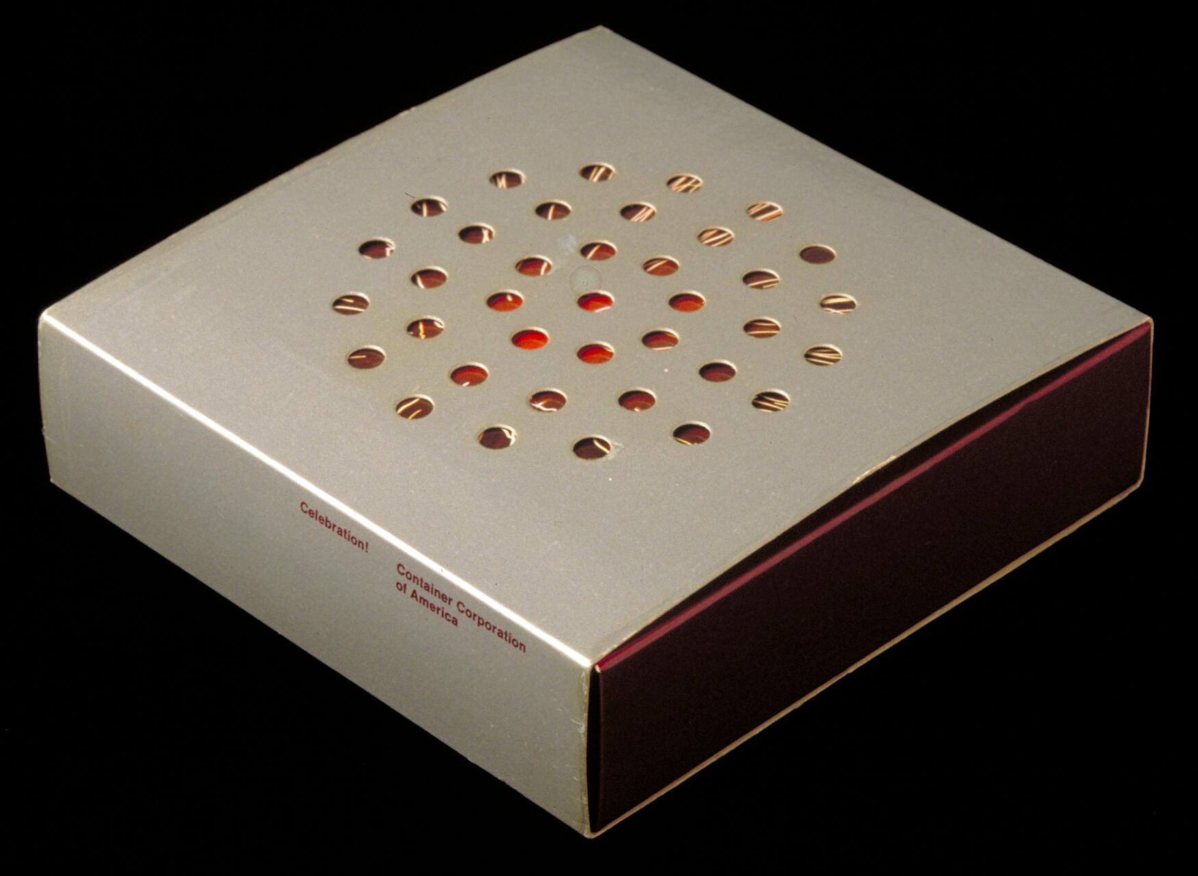 Square beige box with circular cutouts arranged in a grid pattern, revealing a red interior. The side of the box reads "Celebration! Container Corporation of America" in red text.