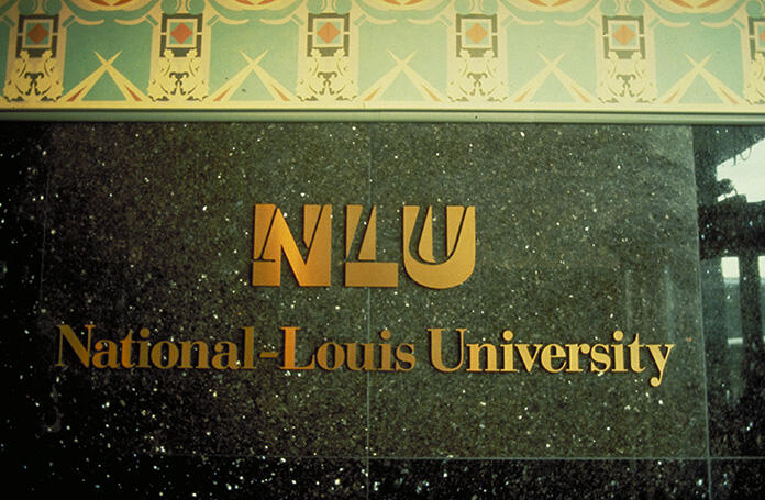 Gold lettering on a dark, speckled wall reads "NLU National-Louis University" with a decorative border above.
