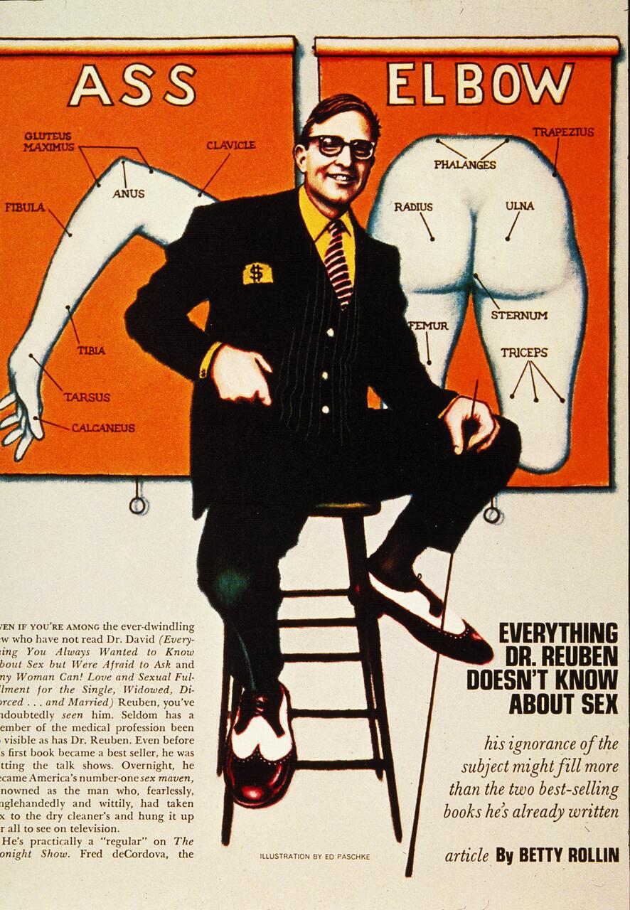 A man in a suit sits on a stool in front of two anatomical diagrams labeled "ASS" and "ELBOW," with corresponding body parts humorously mismatched. The background is orange, and the image includes text about Dr. Reuben.