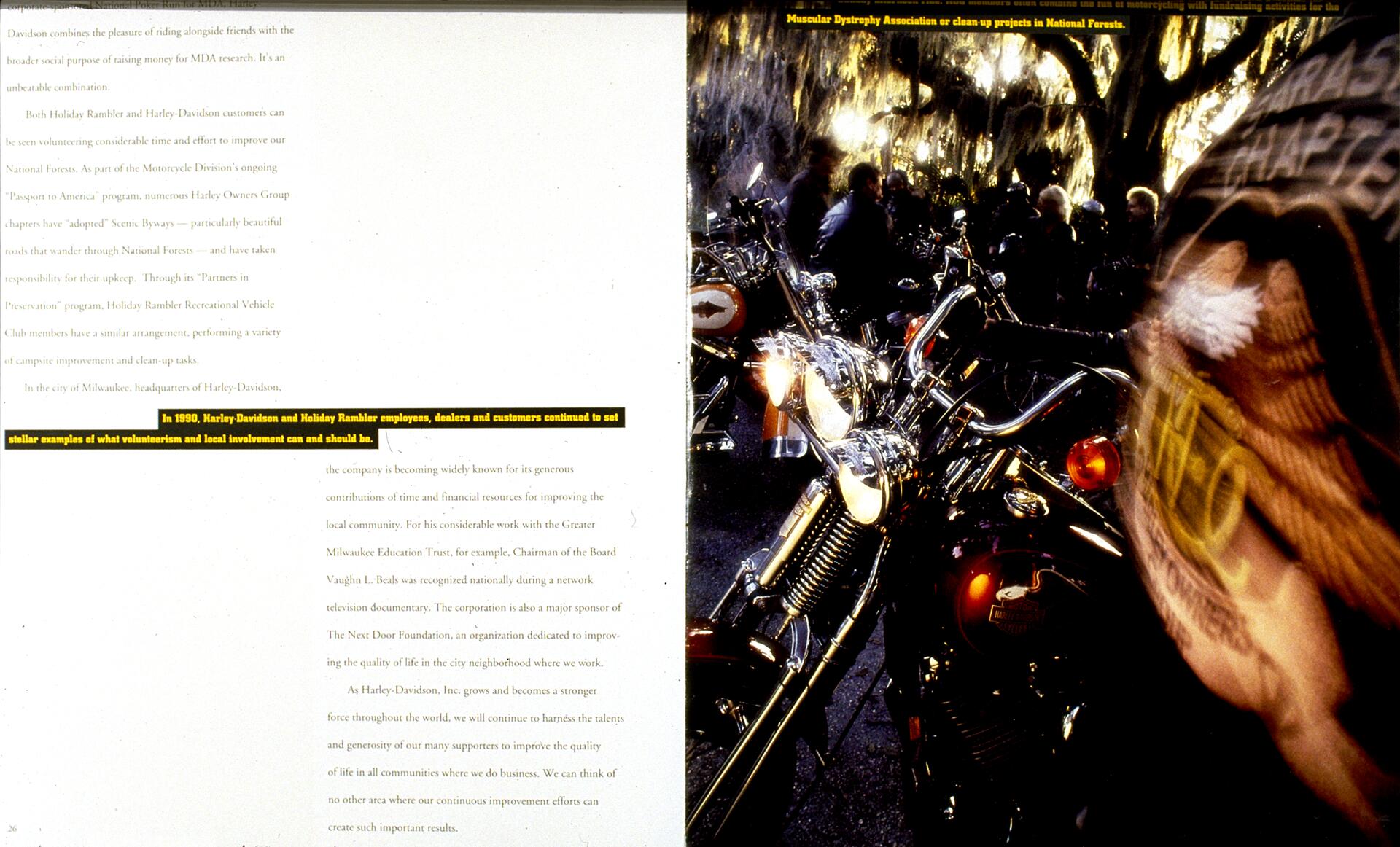 Text on the left pages and a photograph on the right. The photo shows a group of people and motorcycles under tree-covered light, with a prominent Harley-Davidson logo on a bike's gas tank. Text mentions volunteerism and local involvement.