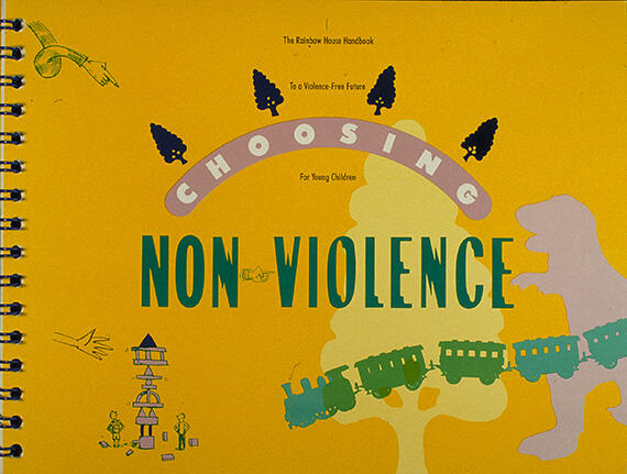 Yellow spiral-bound handbook cover with the title "Choosing Non-Violence" in bold green and pink letters. Illustrations include a dinosaur, trees, a train, and playground equipment, suggesting a child-friendly theme.