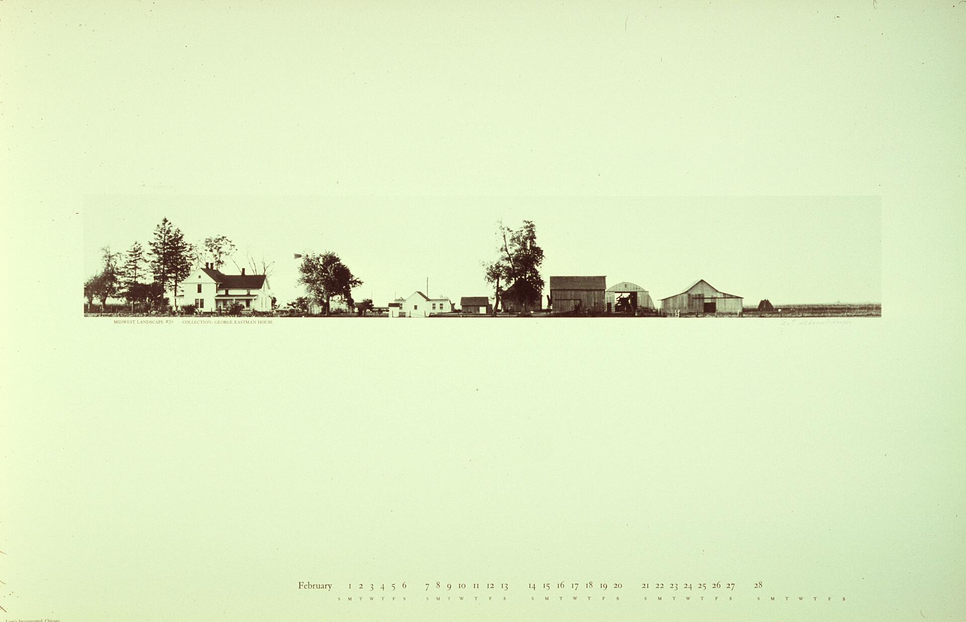 Panoramic view of a rural landscape featuring a series of farm buildings and trees, set against a wide, flat expanse.