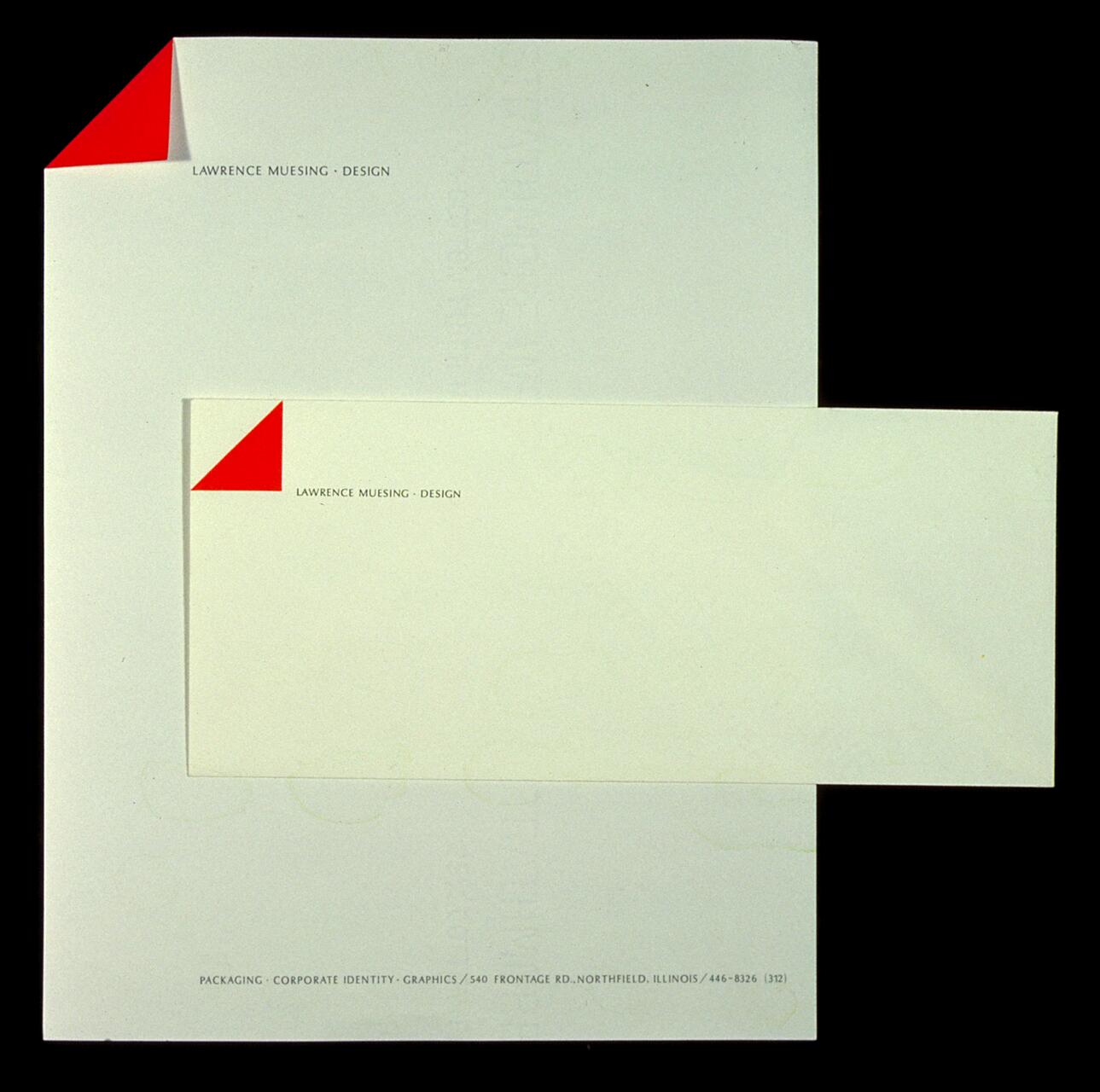 A letterhead and envelope with a minimalist design featuring a red triangular detail in the corner and text reading "Lawrence Muesing Design."