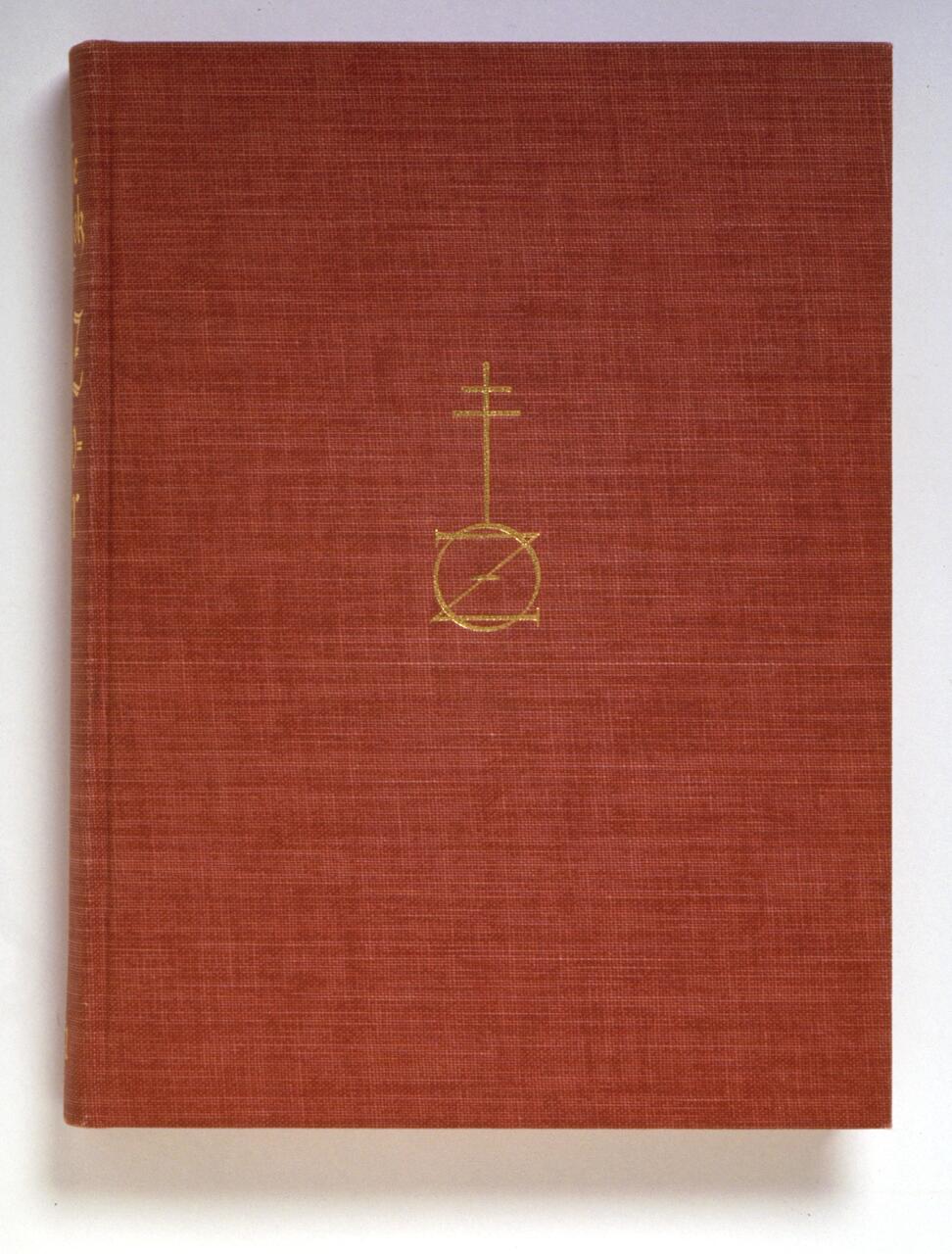 Brown hardcover book with a gold embossed symbol resembling a cross and circle on the front cover.