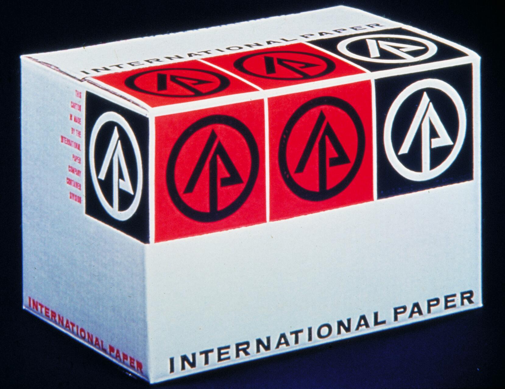 A white box with the "International Paper" logo, featuring red and black circles with stylized letters, is prominently displayed. The text "INTERNATIONAL PAPER" is printed along the bottom in bold letters.