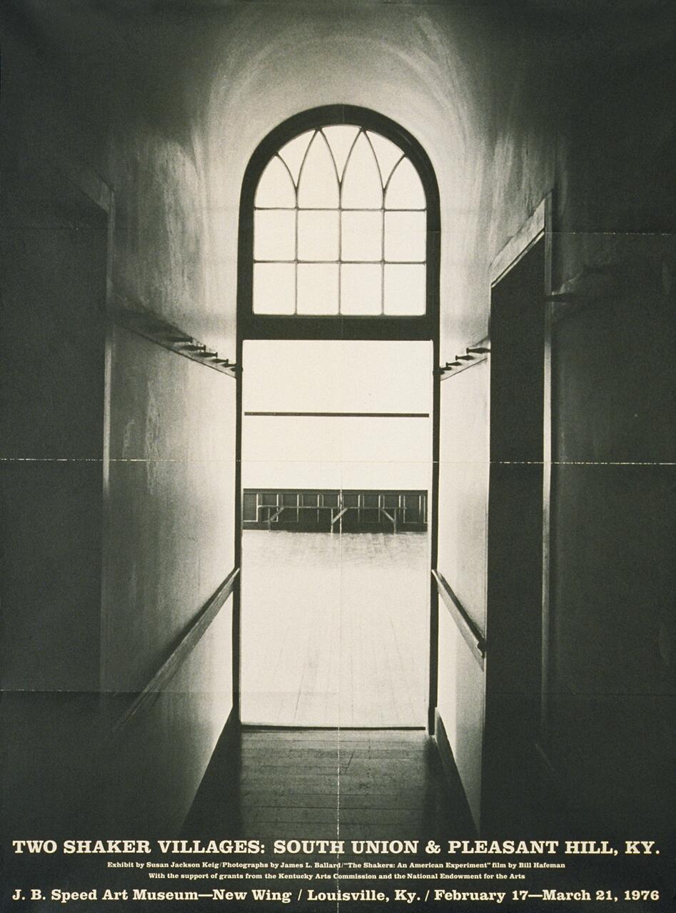 Narrow hallway with arched window at the end, casting soft light onto walls. Photographic exhibition details about Shaker villages at the bottom.