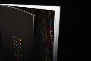 16A-35_Open book black book with colorful square patterns on black pages_Dani Reis